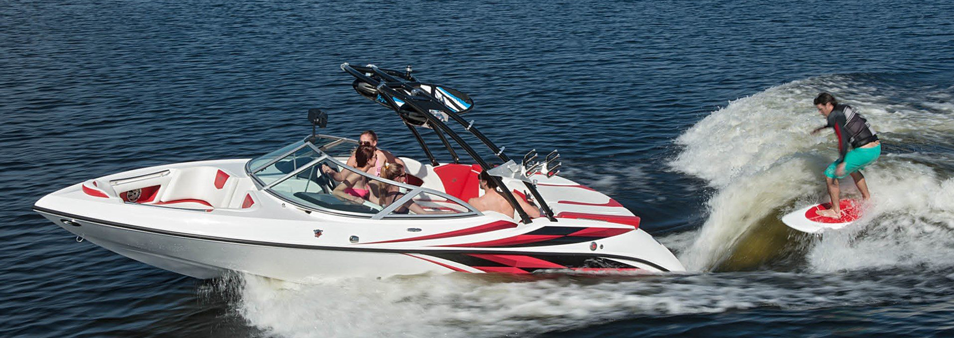 SplashRides platoon boat rental at Lake Lewisville with friend skiing in the back